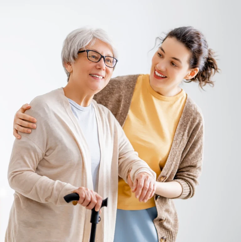 NDIS support worker assisting senior woman with daily mobility using walking aid in Melbourne